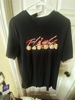 Nike/Jordan Black Tee with Red Flight Script and Gold Ring Graphics